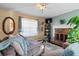 Comfortable living room with a fireplace, plush seating, and natural light from the window at 170 Cobblestone Ct, Douglasville, GA 30134