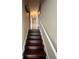 Hallway and stairway leading upstairs featuring wooden steps and white railing at 170 Cobblestone Ct, Douglasville, GA 30134
