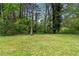 A large backyard is surrounded by mature trees offering privacy at 2405 Clifton Springs Rd, Decatur, GA 30034