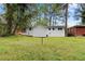 Backyard view to home showing neutral exterior color scheme and treed surroundings at 2405 Clifton Springs Rd, Decatur, GA 30034