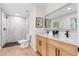 Bathroom featuring double vanities, modern fixtures, tile and glass shower at 2405 Clifton Springs Rd, Decatur, GA 30034