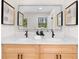 Bathroom featuring double vanities, modern fixtures, and neutral decor at 2405 Clifton Springs Rd, Decatur, GA 30034