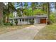 Charming one-story home with white brick, covered parking, and a spacious front yard at 2405 Clifton Springs Rd, Decatur, GA 30034
