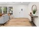 Bright foyer with wood-look floors, a white front door, and tasteful decor at 2405 Clifton Springs Rd, Decatur, GA 30034