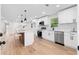 Bright kitchen features white cabinets, stainless steel appliances, island and hardwood flooring at 2405 Clifton Springs Rd, Decatur, GA 30034
