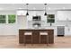 Well-lit kitchen with white cabinetry, stainless steel appliances, and a stylish island with seating at 2405 Clifton Springs Rd, Decatur, GA 30034