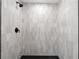 Walk-in shower featuring neutral tile design and modern shower head at 2405 Clifton Springs Rd, Decatur, GA 30034