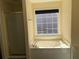 Bright bathroom features a soaking tub with a window and shower at 3259 S Pointe Ct, Atlanta, GA 30340