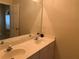 Bathroom featuring a double sink vanity with a large mirror at 3259 S Pointe Ct, Atlanta, GA 30340