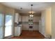 Well-lit kitchen features white cabinets, a tile backsplash, wooden floor and modern appliances at 3259 S Pointe Ct, Atlanta, GA 30340