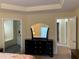 Spacious primary bedroom features a dresser with mirror and en suite bath and walk-in closet entrances at 3259 S Pointe Ct, Atlanta, GA 30340