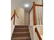Carpeted staircase with wooden handrails and white balusters leads to the upper level of the home at 3259 S Pointe Ct, Atlanta, GA 30340
