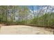 Spacious backyard with concrete court and basketball hoop surrounded by a wooden fence at 2138 Bramlett Nw Pl, Marietta, GA 30064