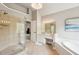 Bathroom featuring a walk-in shower with glass door, separate tub, vanity, and tile flooring at 2138 Bramlett Nw Pl, Marietta, GA 30064