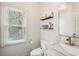 Bright bathroom featuring marble countertop, chrome faucet, and decorative shelves at 2138 Bramlett Nw Pl, Marietta, GA 30064