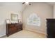 Charming bedroom with a vaulted ceiling, neutral carpet, and an arched window with blinds at 2138 Bramlett Nw Pl, Marietta, GA 30064