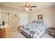 Relaxing bedroom featuring a patterned quilt, a ceiling fan, and a view to the hallway at 2138 Bramlett Nw Pl, Marietta, GA 30064