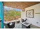 Covered deck with seating area, rug and outdoor view surrounded by tall trees at 2138 Bramlett Nw Pl, Marietta, GA 30064