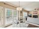 Bright breakfast nook featuring windows, pillar and chandelier, open to living room at 2138 Bramlett Nw Pl, Marietta, GA 30064