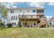 Back exterior view of two-story home with deck, porch and grassy yard with mature trees at 2138 Bramlett Nw Pl, Marietta, GA 30064