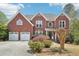 Charming two-story brick home with a two-car garage and a well-manicured lawn at 2138 Bramlett Nw Pl, Marietta, GA 30064