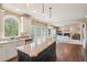 Open kitchen with an island, stainless steel appliances, white cabinets, and a view into the living room at 2138 Bramlett Nw Pl, Marietta, GA 30064