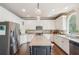 Spacious kitchen featuring white cabinets, a dark island, stainless steel appliances, and granite countertops at 2138 Bramlett Nw Pl, Marietta, GA 30064