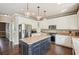 Bright kitchen featuring white cabinets, a dark island, stainless steel appliances, and granite countertops at 2138 Bramlett Nw Pl, Marietta, GA 30064