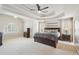 Spacious main bedroom with tray ceilings, a ceiling fan, carpet, and generous natural light at 2138 Bramlett Nw Pl, Marietta, GA 30064