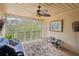 Relaxing screened porch with wood floors and ceiling, stylish ceiling fan, and comfortable furnishings at 2138 Bramlett Nw Pl, Marietta, GA 30064