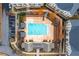 Aerial view of the square community pool, cabanas, surrounding landscaping, and the nearby parking lot at 3933 Danube Ln # 224, Atlanta, GA 30339