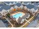 Aerial view of the community pool area, featuring a pool, cabanas, and manicured landscaping at 3933 Danube Ln # 224, Atlanta, GA 30339