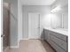 Bathroom featuring grey cabinets, double vanity, and glass shower at 3933 Danube Ln # 224, Atlanta, GA 30339