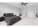 Spacious bedroom featuring light carpet and a ceiling fan at 3933 Danube Ln # 224, Atlanta, GA 30339