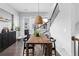 Inviting dining area with a rustic wooden table, modern light fixture, and access to the outdoor patio at 3933 Danube Ln # 224, Atlanta, GA 30339
