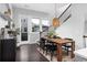 Stylish dining area with modern light fixture, wooden table, and access to a cozy outdoor patio at 3933 Danube Ln # 224, Atlanta, GA 30339