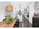 A long wooden dining room table sits next to an island and galley kitchen in an open concept home at 3933 Danube Ln # 224, Atlanta, GA 30339