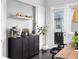 Open dining area with stylish black cabinetry, modern espresso machine and floating shelves for decor at 3933 Danube Ln # 224, Atlanta, GA 30339