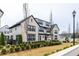 New construction townhome featuring manicured lawn, painted brick, black trim, and private outdoor living space at 3933 Danube Ln # 224, Atlanta, GA 30339