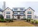 Charming exterior of a multi-story townhouse with brick facade, black-framed windows, and manicured landscaping at 3933 Danube Ln # 224, Atlanta, GA 30339