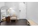 This is a modern foyer with a door, mirror, light, hardwood floors, and a shoe rack at 3933 Danube Ln # 224, Atlanta, GA 30339