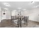 Hallway with wooden floors and banisters that overlooks stairs leading down to the lower level at 3933 Danube Ln # 224, Atlanta, GA 30339