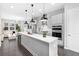 Open-concept kitchen featuring a large island, stainless steel appliances, and modern pendant lighting at 3933 Danube Ln # 224, Atlanta, GA 30339
