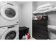 Functional laundry area with stacked washer and dryer and dark storage maximizing space at 3933 Danube Ln # 224, Atlanta, GA 30339
