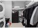 Practical laundry area with washer, dryer, storage, and clothing rack maximizing space at 3933 Danube Ln # 224, Atlanta, GA 30339