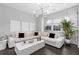 Airy living room featuring a large white sectional sofa, stylish decor, and a contemporary light fixture at 3933 Danube Ln # 224, Atlanta, GA 30339