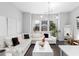 Bright living room with a large white sectional sofa, modern light fixture, and dark hardwood floors at 3933 Danube Ln # 224, Atlanta, GA 30339
