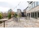 Outdoor patio featuring stone floors, a stone wall, string lights, and tables with chairs for outdoor lounging at 3933 Danube Ln # 224, Atlanta, GA 30339