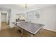 Spacious basement with a ping pong table and open access to a living area at 4215 Homestead Ridge Dr, Cumming, GA 30041