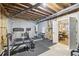 Basement workout area with equipment, weights, and access to another room, perfect for fitness enthusiasts at 4215 Homestead Ridge Dr, Cumming, GA 30041
